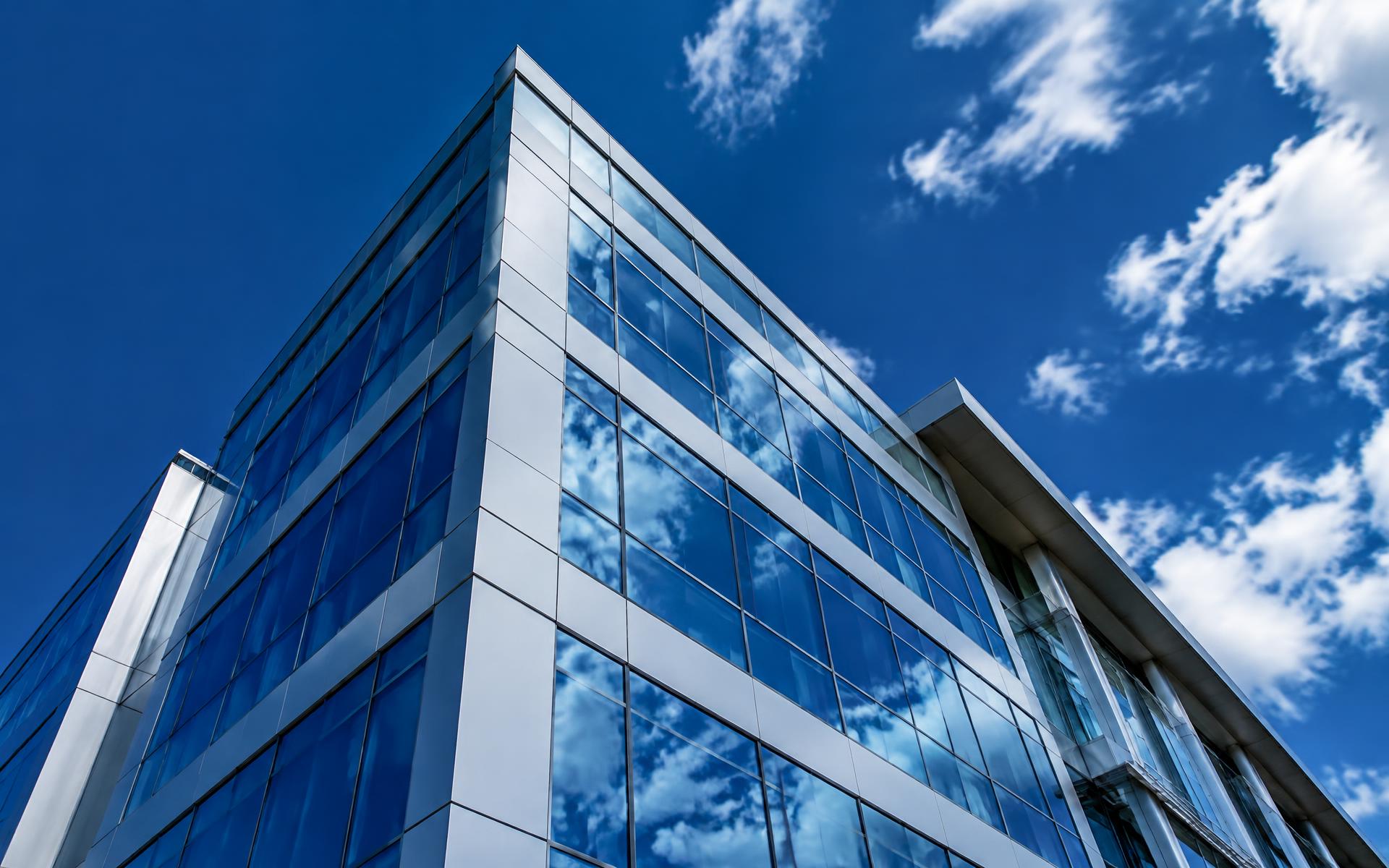 Glass and aluminum building against blue sky
